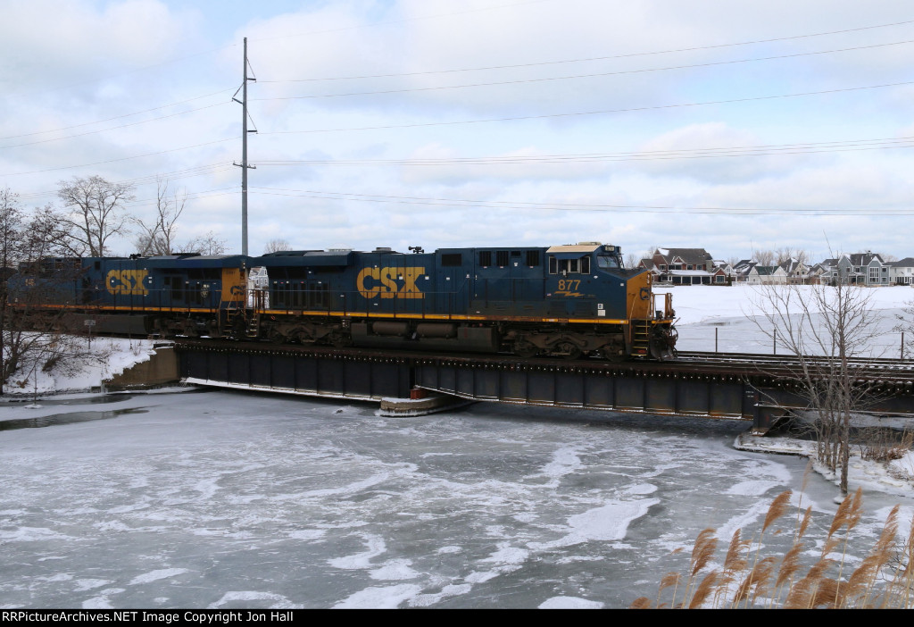 CSX 877 slowly rolls over the low bridge at the confluence of the Paw Paw and St Joseph Rivers